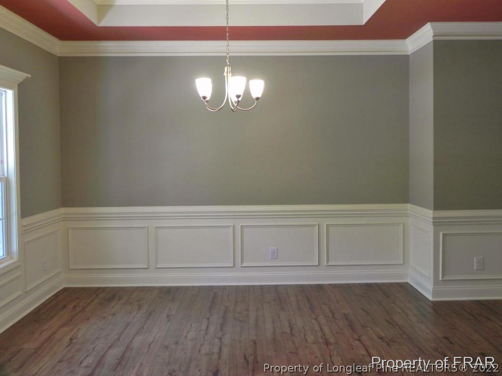 1280 Rays Bridge Road Whispering Pines, NC 28327 - Photo 4 of 22 a view of an empty room with wooden floor