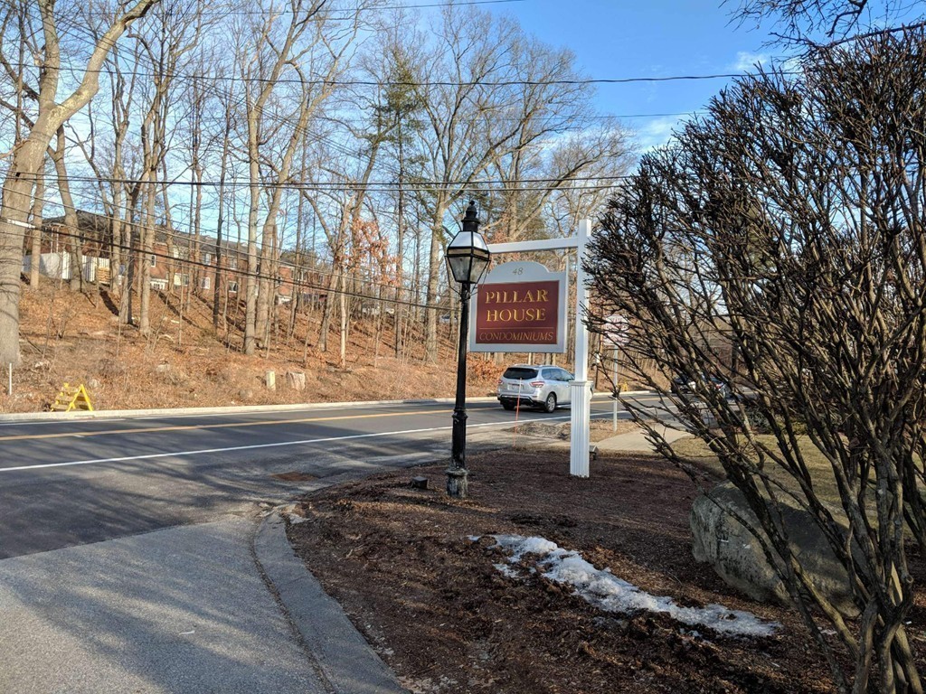 48 Great Road, Unit 22 Acton, MA 01720 - Photo 15 of 18 a sign board with a bench in the background