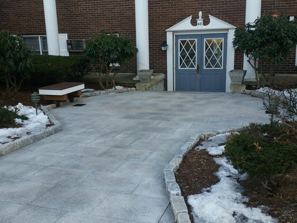 48 Great Road, Unit 22 Acton, MA 01720 - Photo 2 of 18 a front view of a house with a yard and garage