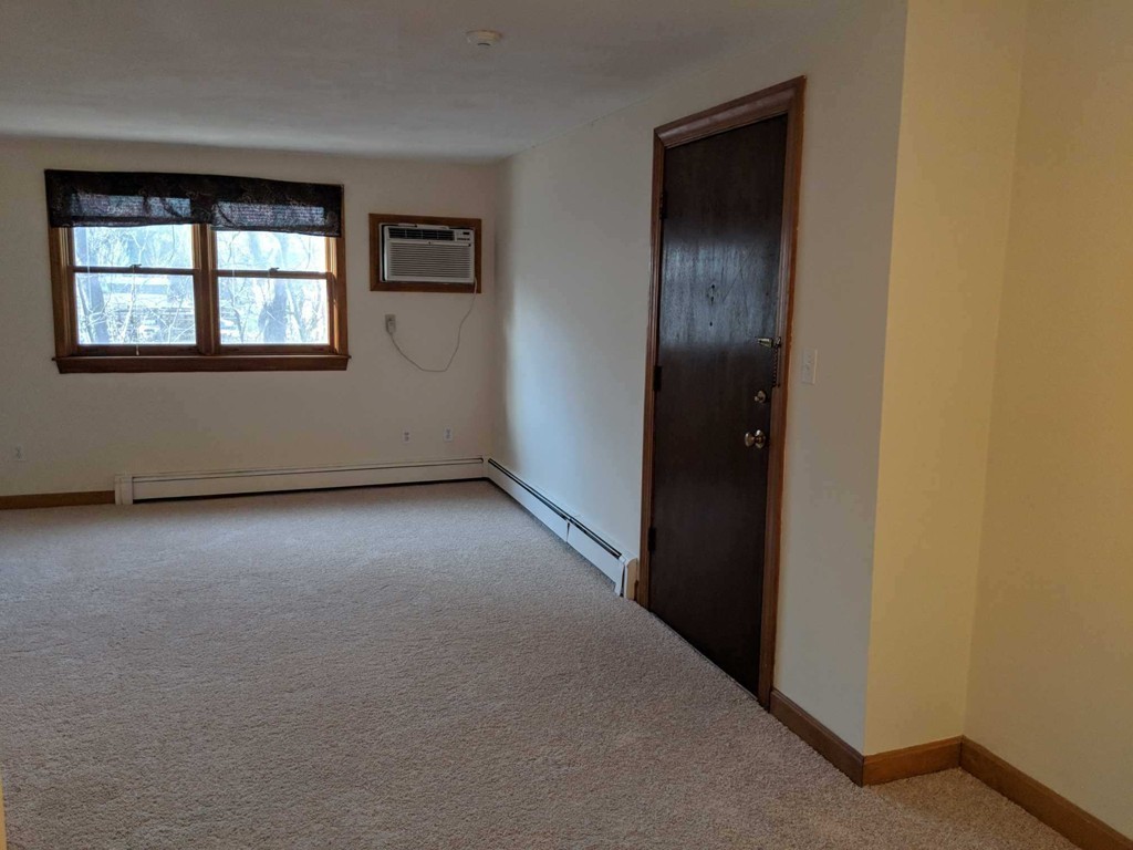 48 Great Road, Unit 22 Acton, MA 01720 - Photo 9 of 18 an empty room with windows and closet