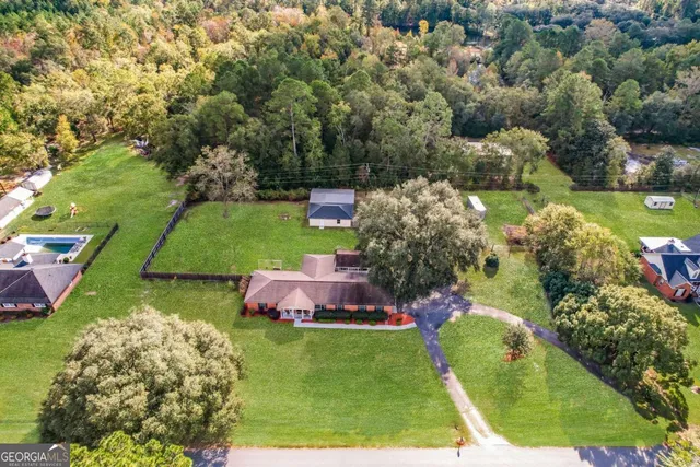 a front view of a house with yard and green space