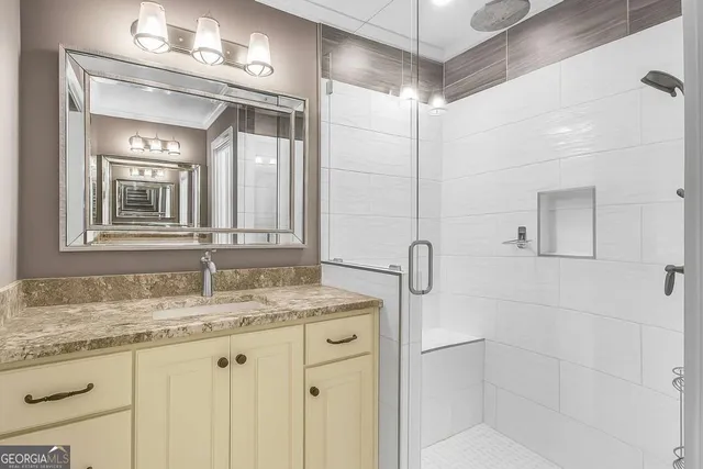 a bathroom with a granite countertop sink vanity mirror and toilet