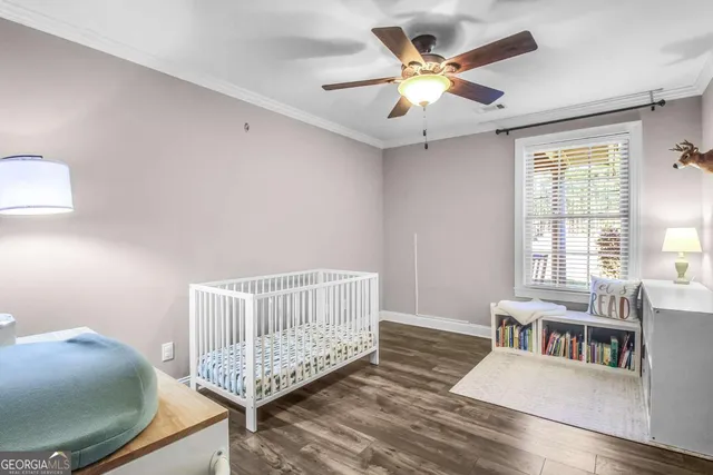 a bathroom with a granite countertop sink toilet and large mirror