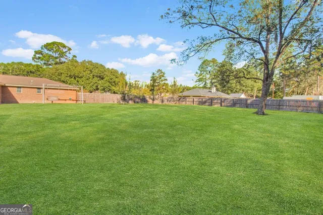 a backyard of a house with lots of green space