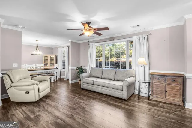 a view of a dining room with furniture window and wooden floor