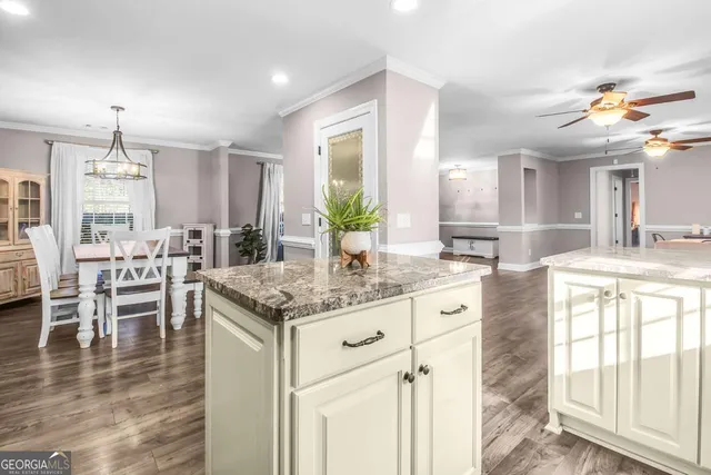 a living room with furniture floor to ceiling window and a flat screen tv