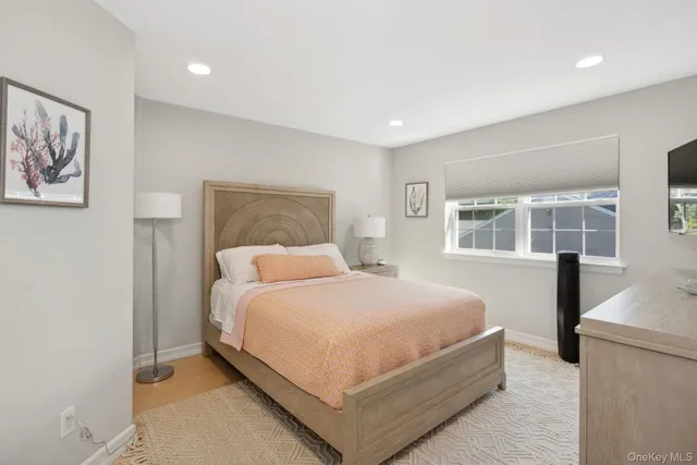 a bedroom with a large bed and a window