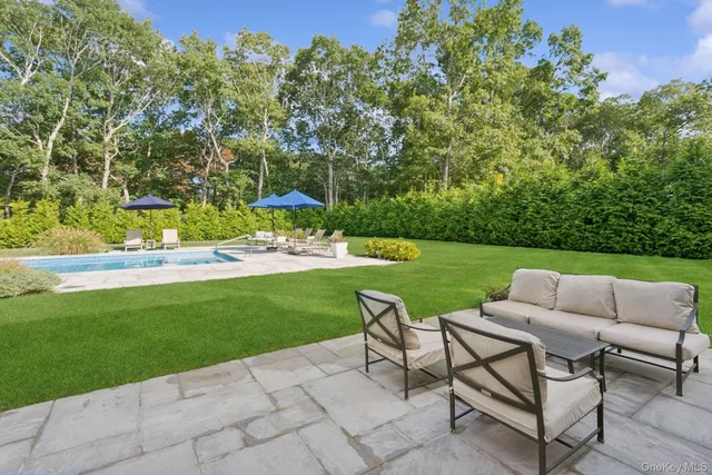 a view of a garden with lawn chairs