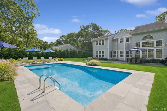 a view of a house with swimming pool and yard