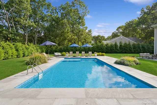 a view of a swimming pool with an outdoor seating