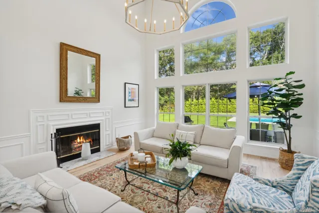 a living room with furniture a fireplace and a large window