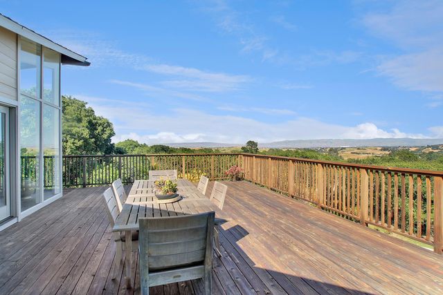 a view of a balcony with wooden floor and outdoor space