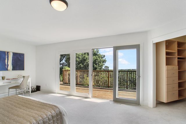 a bedroom with a bed and glass door