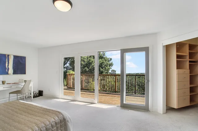 a bedroom with a bed and glass door