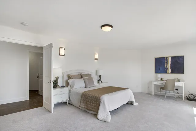 a bedroom with a bed and a couch