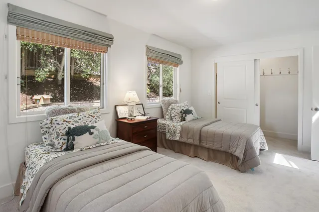 a bedroom with a bed and a large window