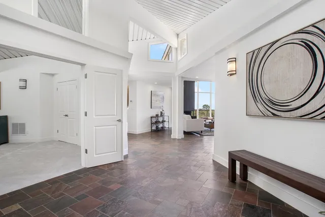 a view of a livingroom with furniture and a fan