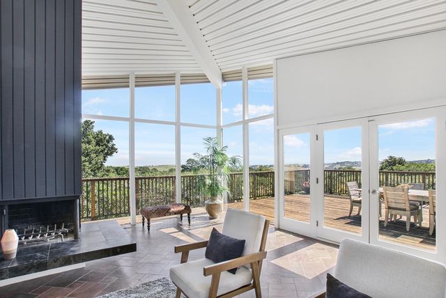a living room with furniture and large windows