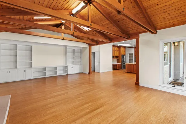 a kitchen with kitchen island granite countertop a sink window and cabinets