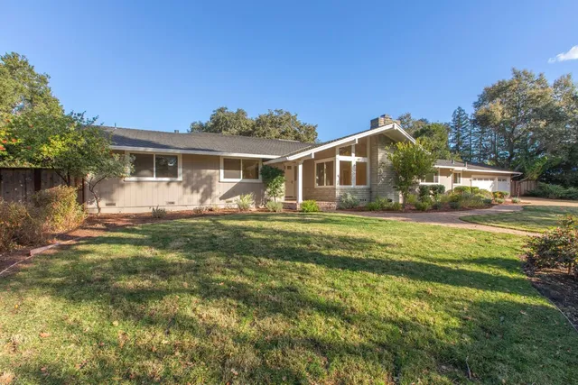 a front view of house with yard and green space
