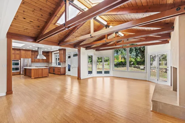 a kitchen with granite countertop cabinets stainless steel appliances a sink and a window