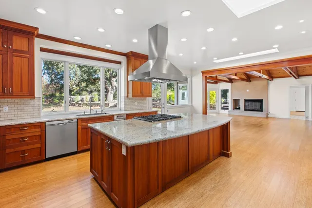 a bathroom with a tub a sink and mirror