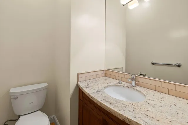 a view of a livingroom with wooden floor and a fireplace