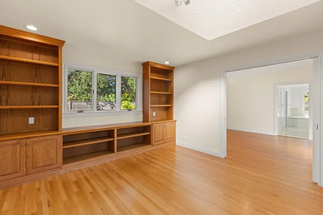 a bathroom with double vanity sinks a vanity a lamp and a large mirror