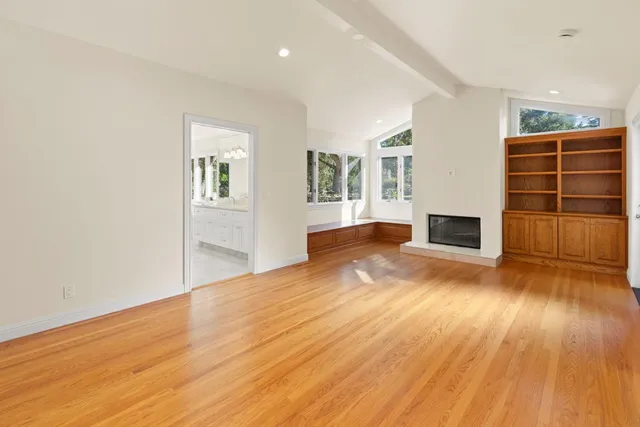 a view of a yard in front of a house with a large tree