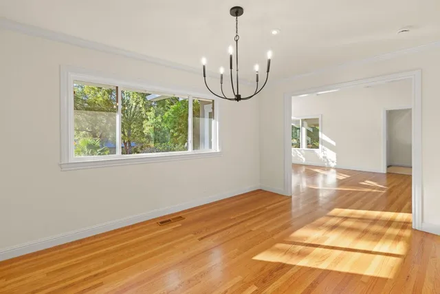 a view of an empty room with a fireplace and a window