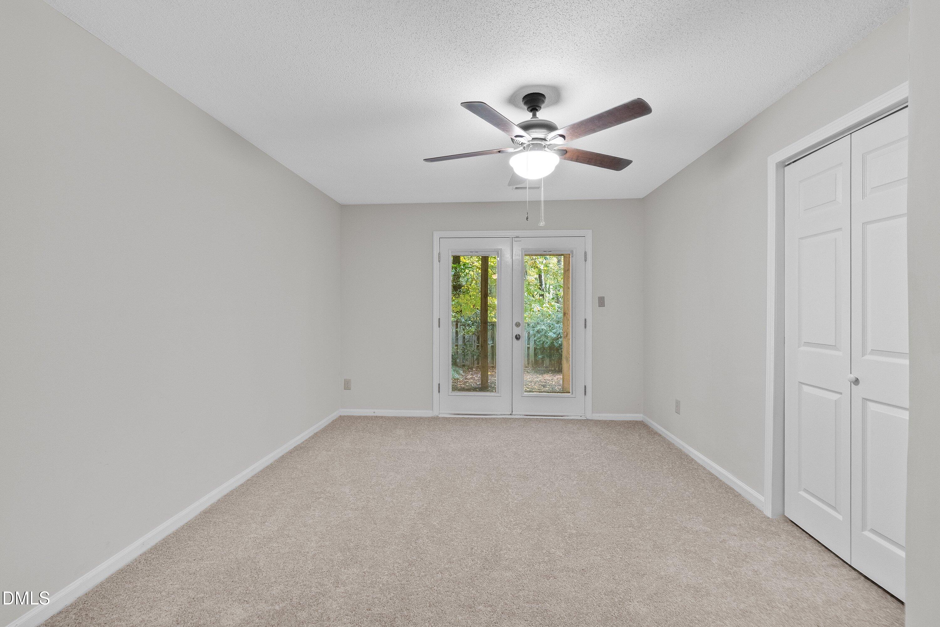 1516 Hemphill Drive Raleigh, NC 27609 - Photo 14 of 28 an empty room with windows and fan