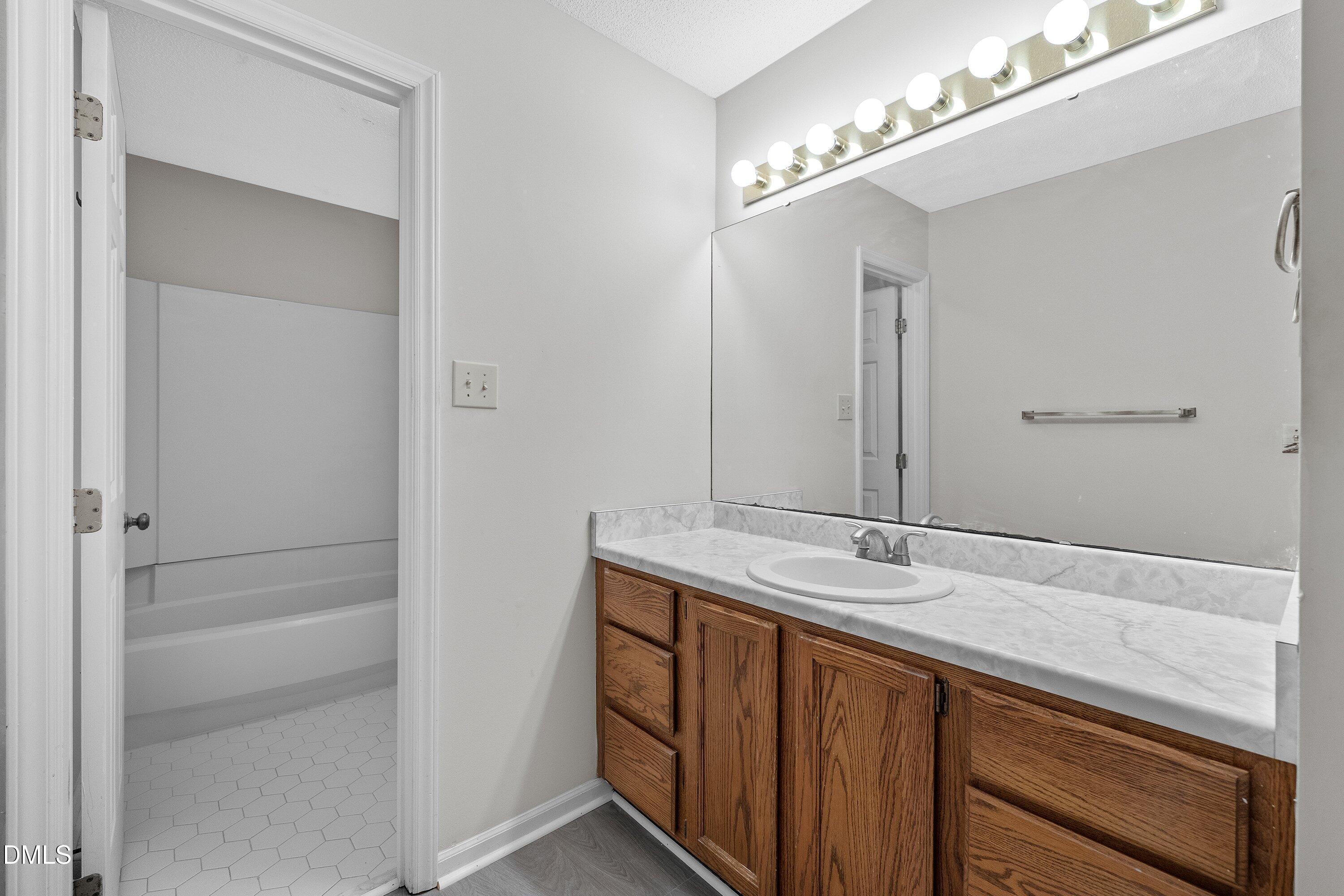 1516 Hemphill Drive Raleigh, NC 27609 - Photo 17 of 28 a bathroom with a sink and a mirror