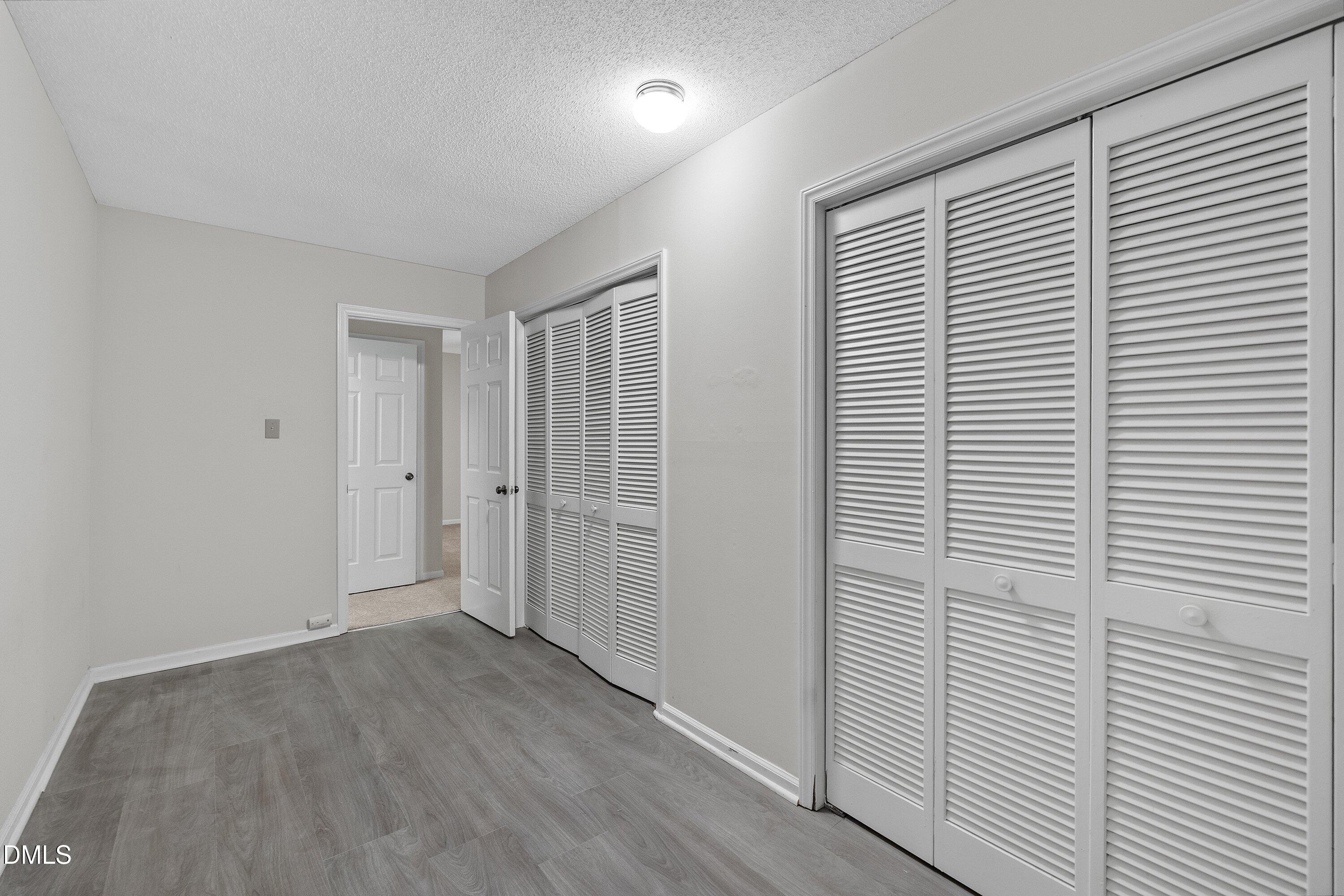1516 Hemphill Drive Raleigh, NC 27609 - Photo 18 of 28 a view of a room with wooden floor and white walls