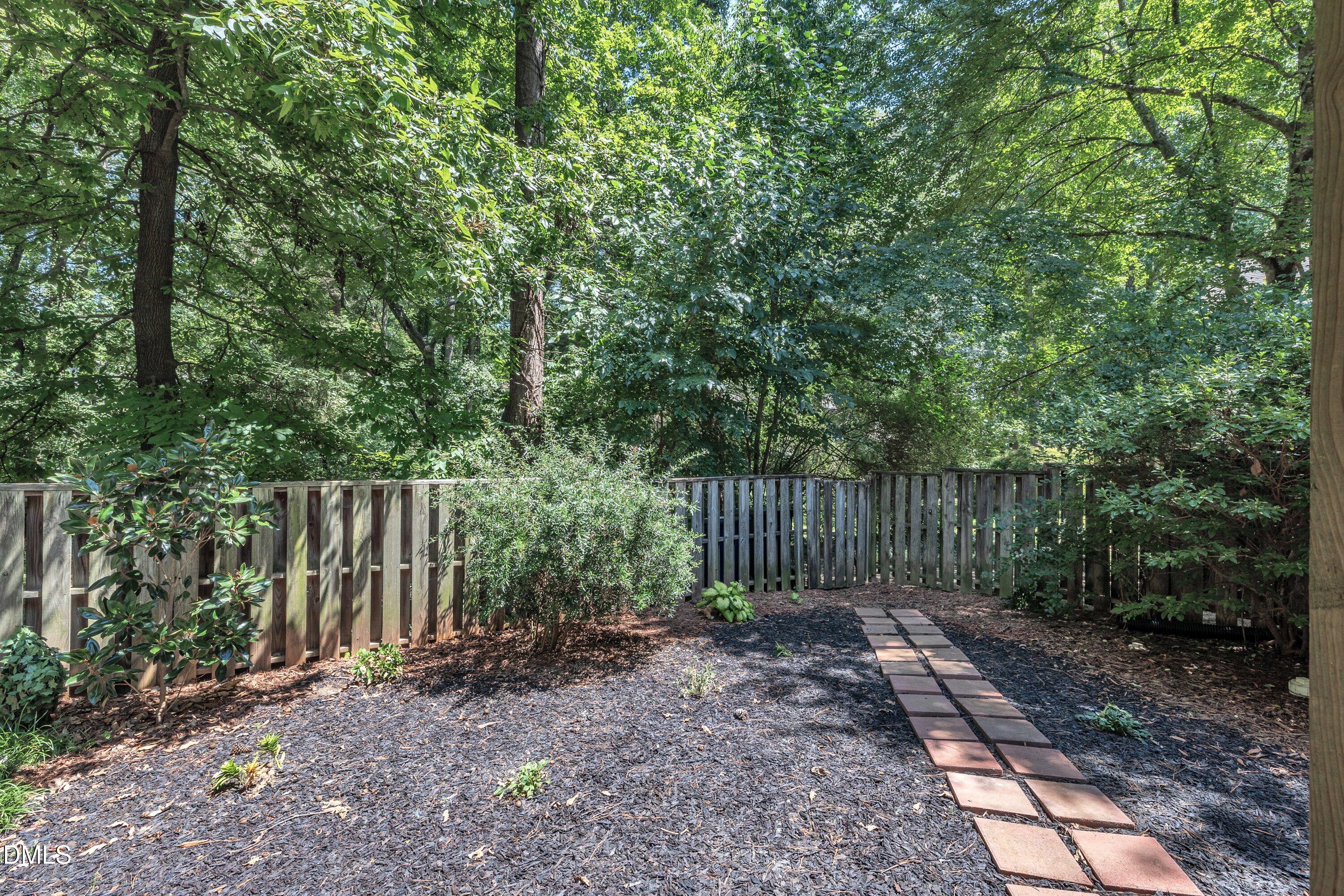 1516 Hemphill Drive Raleigh, NC 27609 - Photo 22 of 28 a view of backyard with green space and wooden fence