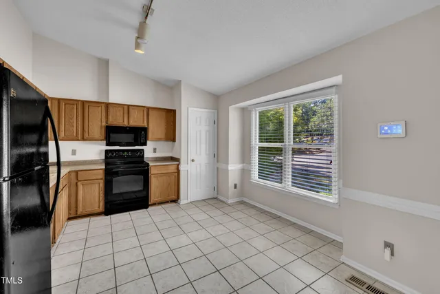 a kitchen with stainless steel appliances a refrigerator and a stove top oven