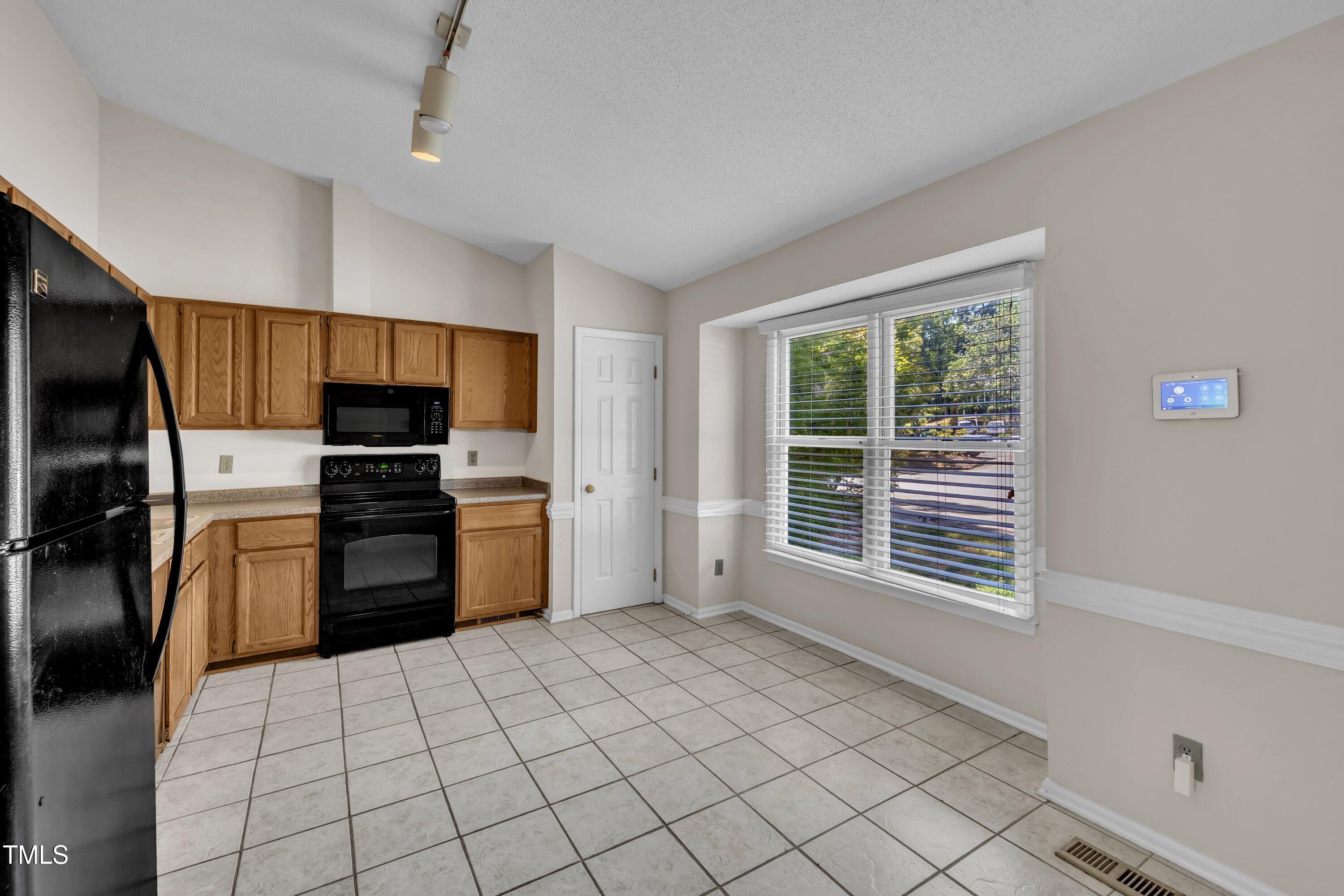 1516 Hemphill Drive Raleigh, NC 27609 - Photo 7 of 28 a kitchen with stainless steel appliances a refrigerator and a stove top oven
