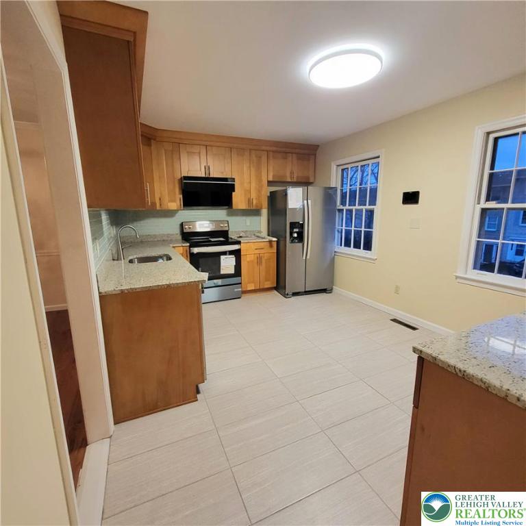 1081 Barnside Road Allentown, PA 18103 - Photo 6 of 25 a kitchen with stainless steel appliances granite countertop a refrigerator and a stove top oven