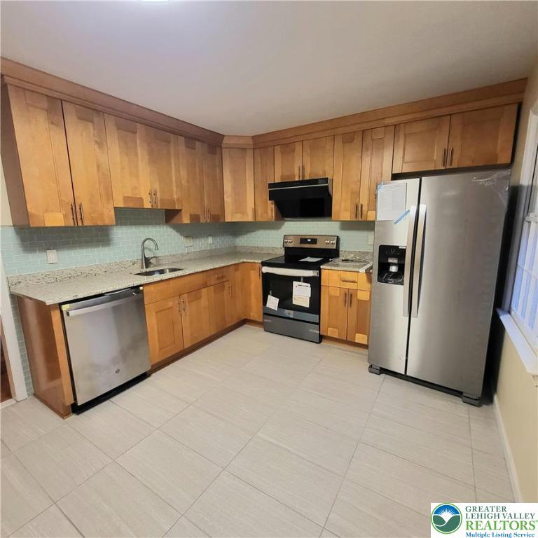 1081 Barnside Road Allentown, PA 18103 - Photo 7 of 25 a kitchen with stainless steel appliances granite countertop a stove a sink dishwasher a refrigerator and a microwave