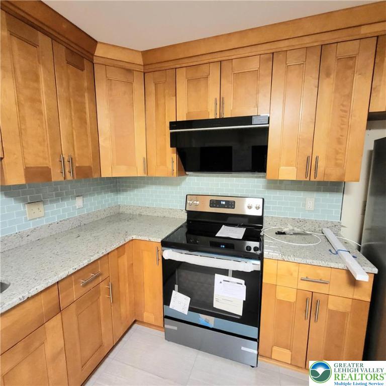 1081 Barnside Road Allentown, PA 18103 - Photo 8 of 25 a kitchen with granite countertop cabinets stainless steel appliances and a counter space