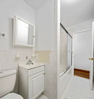 a bathroom with a sink toilet vanity and tub