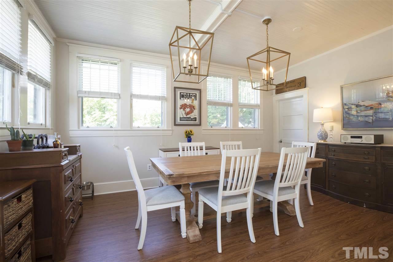 720 North Bloodworth Street Raleigh, NC 27604 - Photo 14 of 27 a view of a dining room with furniture a chandelier and wooden floor