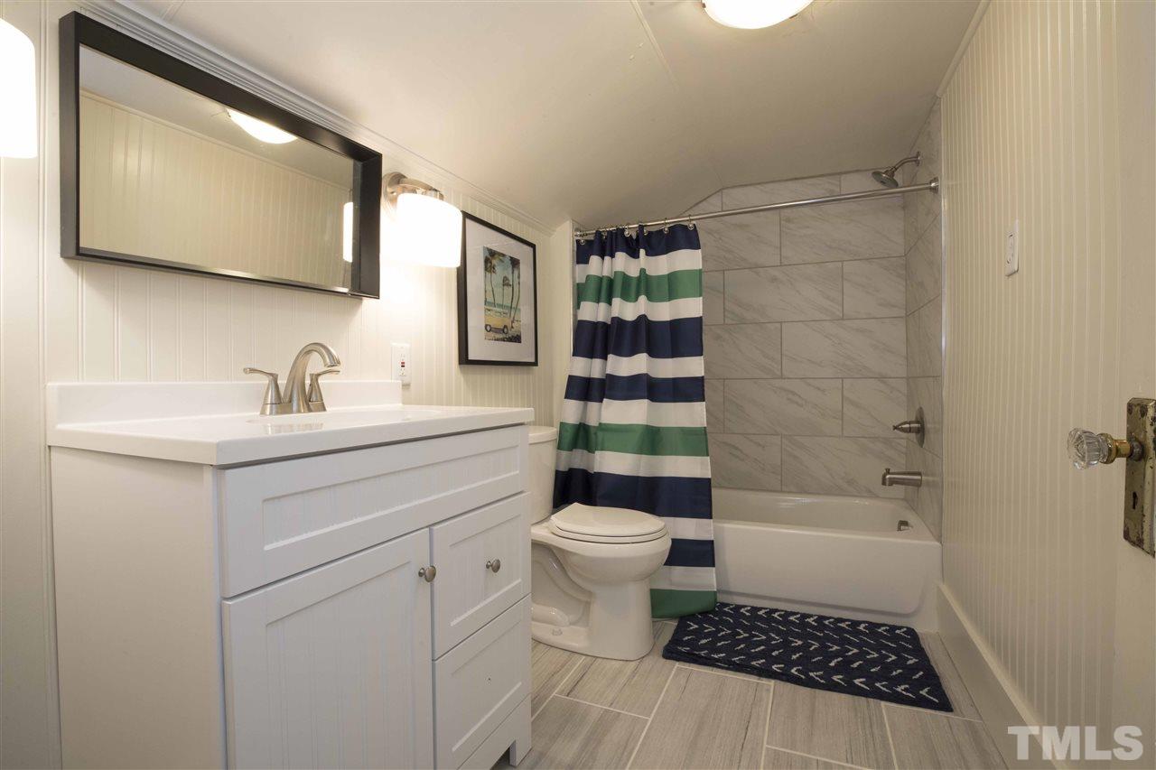 720 North Bloodworth Street Raleigh, NC 27604 - Photo 21 of 27 a bathroom with a sink a toilet and shower