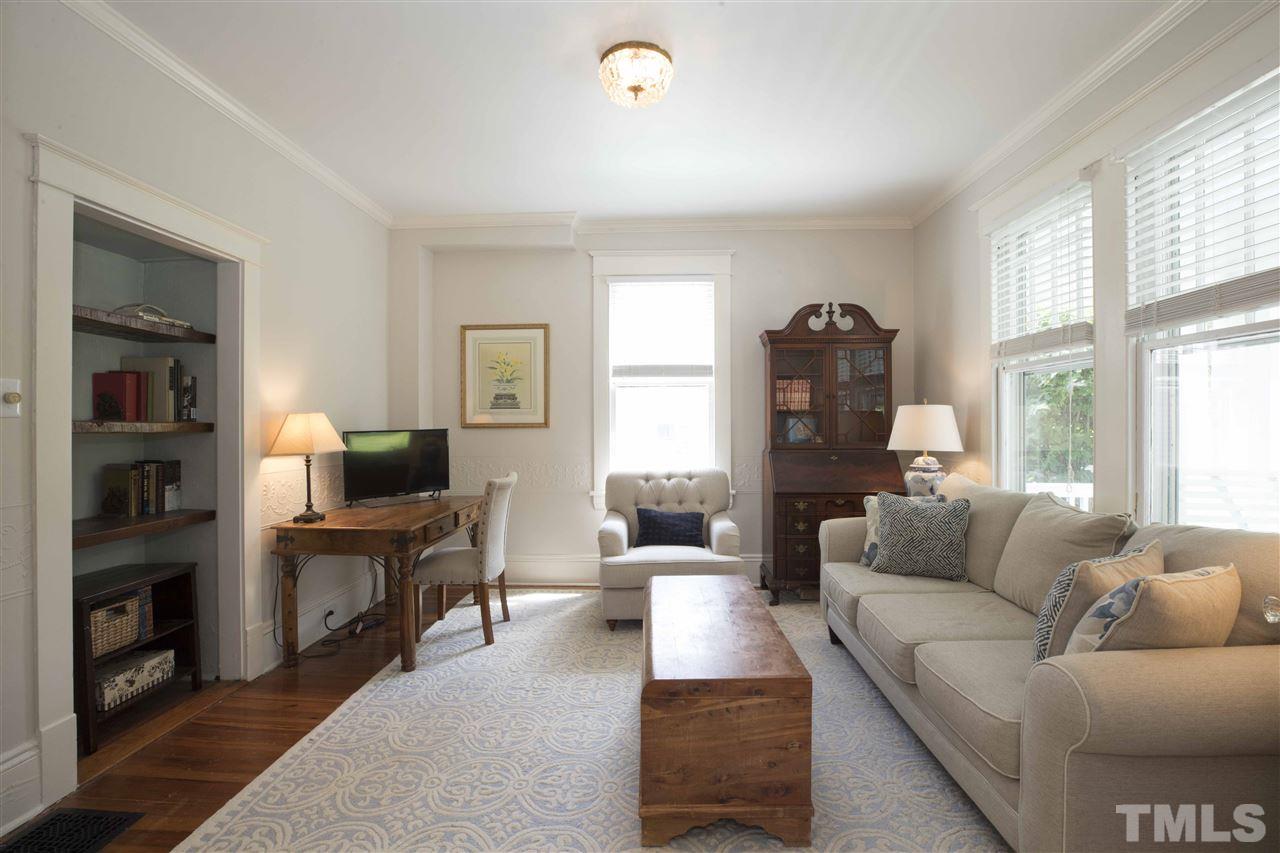 720 North Bloodworth Street Raleigh, NC 27604 - Photo 4 of 27 a living room with furniture a large window and a flat screen tv
