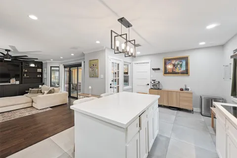 a bedroom with a bed a window and a chandelier