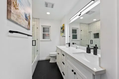 a spacious bedroom with a bed and a flat screen tv