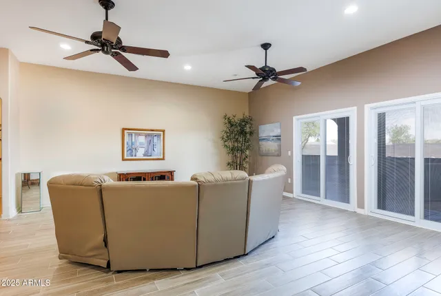 a spacious bedroom with a bed and wooden floor
