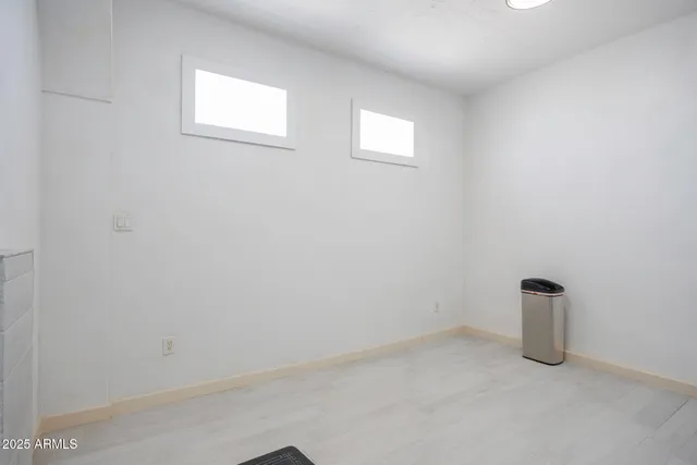 a view of walk in closet with wooden floor