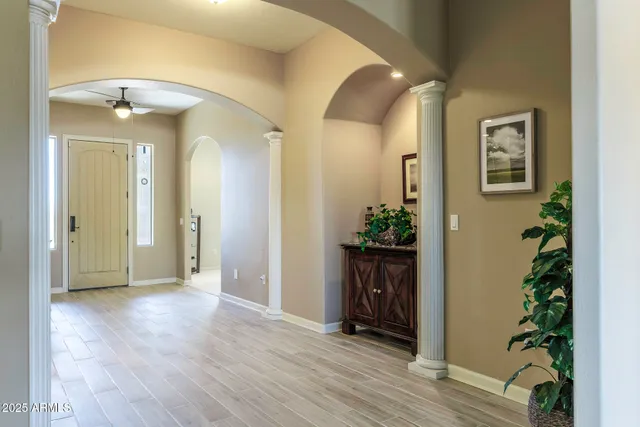 a living room with furniture a window and a ceiling fan
