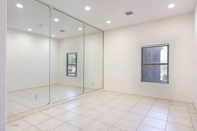 a living room with furniture and a book shelf