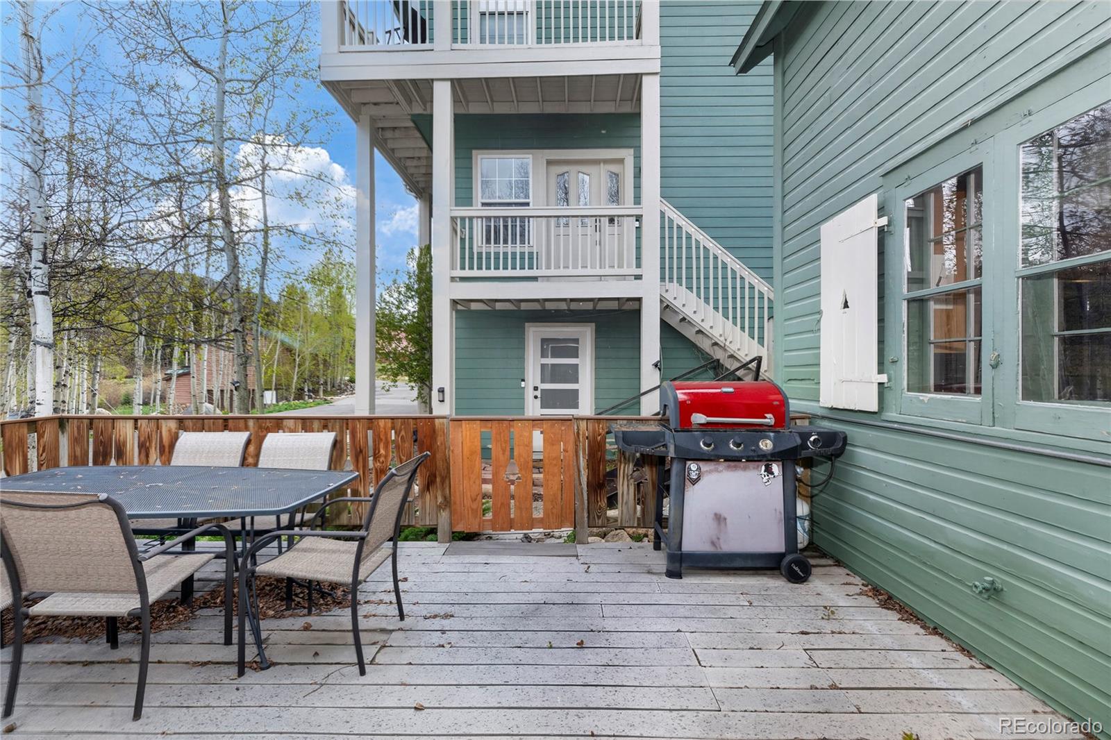 327 Vasquez Road, Unit E1 Winter Park, CO 80482 - Photo 15 of 43 a view of a table and chairs in patio of the house